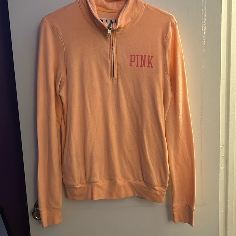 Pink sweater with a zipper and logo on the back size small